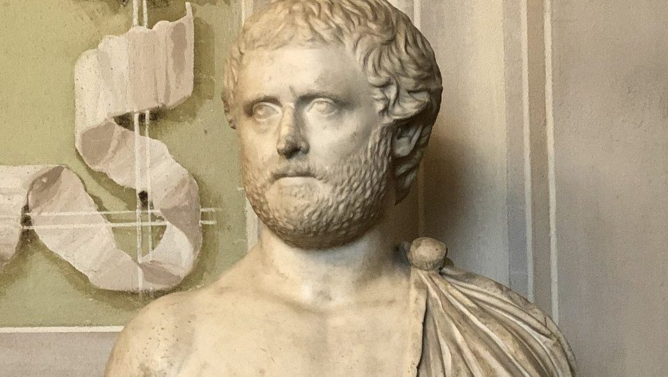 Marble statue of the Roman poet Ovid, depicted seated in thoughtful repose, draped in a toga, symbolizing his exile and reflective nature.