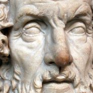 Marble bust of Homer, the ancient Greek poet, showing the traditional depiction of a bearded, blind bard with deeply carved features.