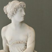 Marble bust of Sappho, the ancient Greek lyric poet, depicted with serene features and wavy hair, symbolizing her enduring poetic grace.