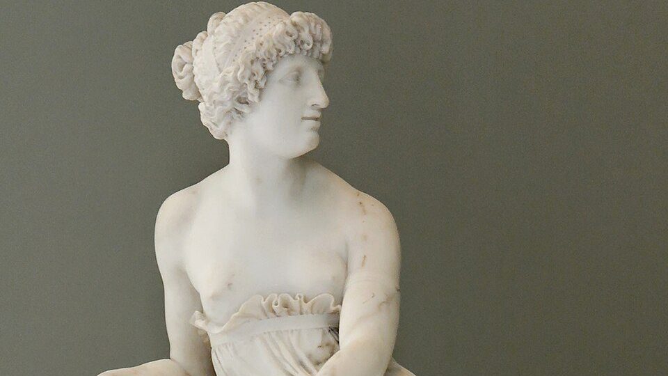 Marble bust of Sappho, the ancient Greek lyric poet, depicted with serene features and wavy hair, symbolizing her enduring poetic grace.